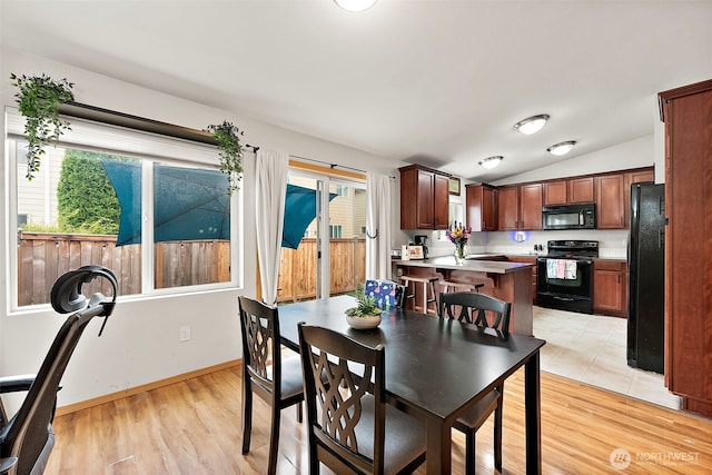 6036 Park St E, Fife, WA 98424 - dining area featuring vaulted ceiling and light wood-type flooring