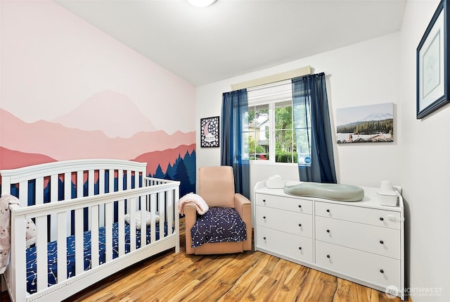6036 Park St E, Fife, WA 98424 - bedroom with light wood-type flooring and a nursery area