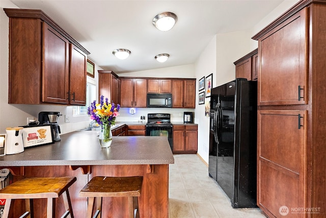 6036 Park St E, Fife, WA 98424 - kitchen featuring black appliances, lofted ceiling, a peninsula, and a breakfast bar area