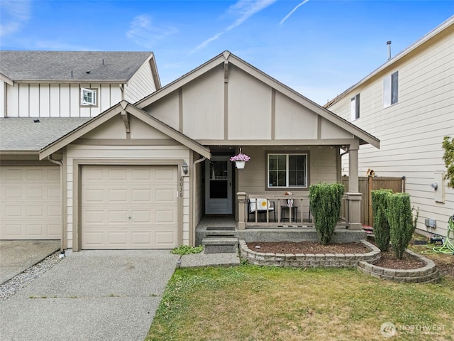 6036 Park St E, Fife, WA 98424 - view of front facade featuring covered porch, concrete driveway, a front lawn, a shingled roof, and board and batten siding