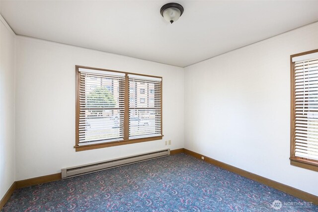 314 E 2nd St, Port Angeles, WA 98362 - spare room featuring a baseboard heating unit and carpet flooring