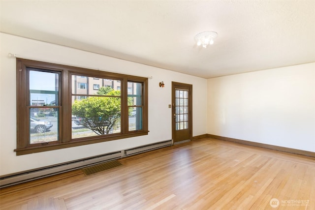 314 E 2nd St, Port Angeles, WA 98362 - spare room featuring baseboard heating and light wood-style floors