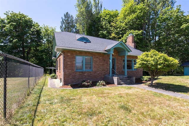 314 E 2nd St, Port Angeles, WA 98362 - view of front of house with a chimney, brick siding, and roof with shingles