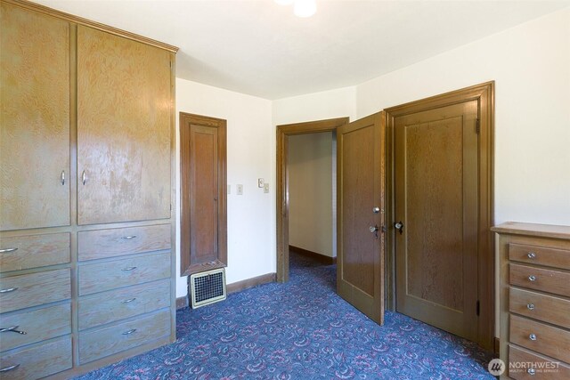 314 E 2nd St, Port Angeles, WA 98362 - unfurnished bedroom featuring baseboards and dark colored carpet