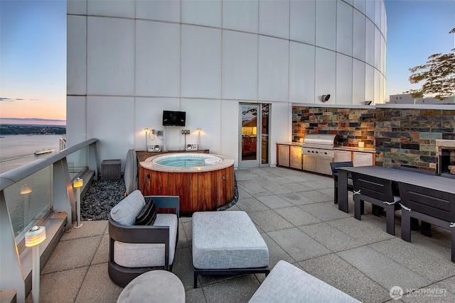 1521 2nd Ave Unit 3801, Seattle, WA 98101 - patio terrace at dusk with a hot tub, exterior kitchen, and a patio area