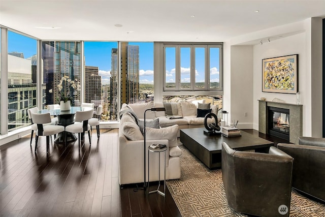 1521 2nd Ave Unit 3801, Seattle, WA 98101 - living area featuring a premium fireplace, dark wood-style floors, a view of city, and expansive windows