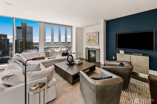 1521 2nd Ave Unit 3801, Seattle, WA 98101 - living room with wood finished floors, a glass covered fireplace, healthy amount of natural light, and a city view