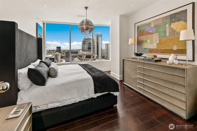 1521 2nd Ave Unit 3801, Seattle, WA 98101 - bedroom with dark wood-style flooring, a view of city, a chandelier, and recessed lighting