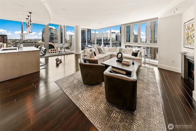 1521 2nd Ave Unit 3801, Seattle, WA 98101 - living area featuring a view of city, dark wood-style floors, a wall of windows, and a glass covered fireplace
