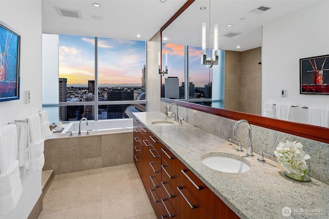 1521 2nd Ave Unit 3801, Seattle, WA 98101 - bathroom featuring a garden tub, double vanity, decorative backsplash, a view of city, and recessed lighting