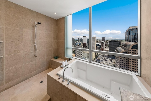 1521 2nd Ave Unit 3801, Seattle, WA 98101 - full bathroom featuring a garden tub, a tile shower, a view of city, and healthy amount of natural light