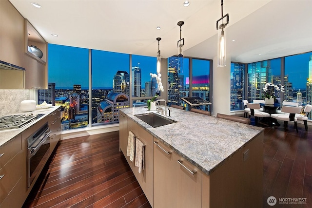 1521 2nd Ave Unit 3801, Seattle, WA 98101 - kitchen with appliances with stainless steel finishes, open floor plan, floor to ceiling windows, dark wood-style floors, and recessed lighting