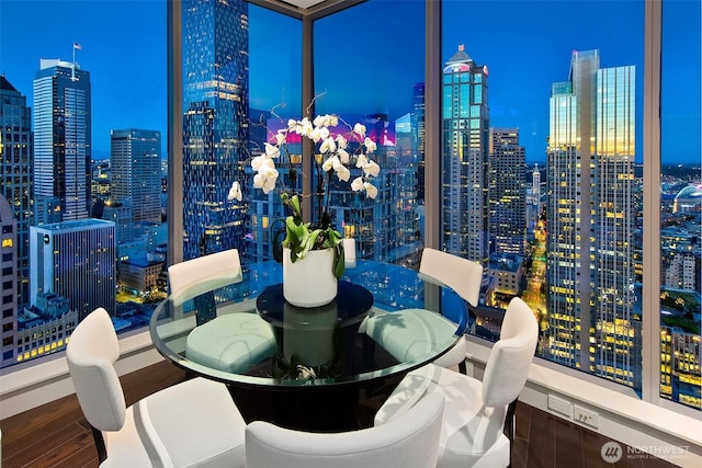 1521 2nd Ave Unit 3801, Seattle, WA 98101 - dining room with wood finished floors and a view of city lights