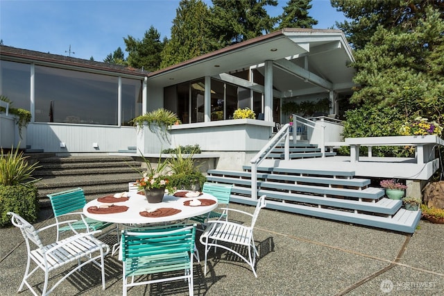 4802 E Mercer Way, Mercer Island, WA 98040 - view of patio / terrace with a sunroom, outdoor dining space, and stairway