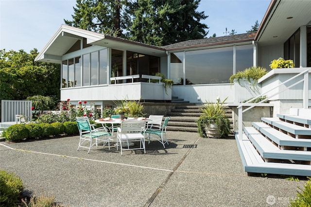 4802 E Mercer Way, Mercer Island, WA 98040 - view of patio featuring a sunroom, outdoor dining space, and stairs