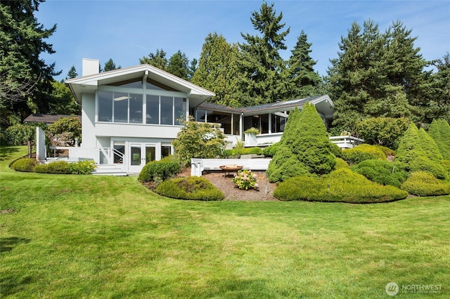 4802 E Mercer Way, Mercer Island, WA 98040 - back of property with a chimney, a sunroom, and a lawn