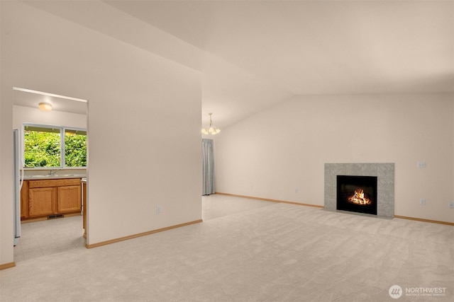 4050 NE 197th St, Lake Forest Park, WA 98155 - unfurnished living room featuring light colored carpet, lofted ceiling, a chandelier, and a premium fireplace