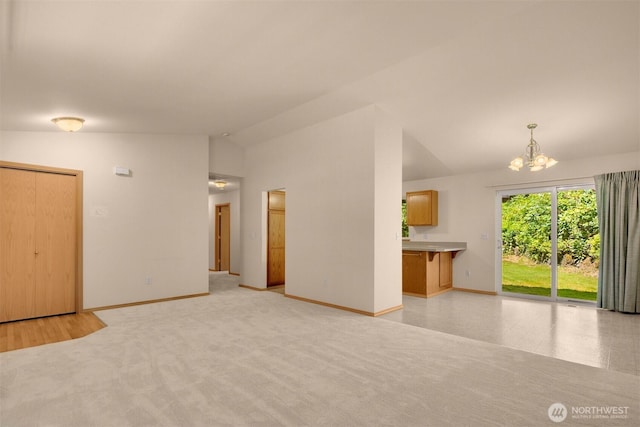 4050 NE 197th St, Lake Forest Park, WA 98155 - unfurnished living room featuring lofted ceiling and a chandelier