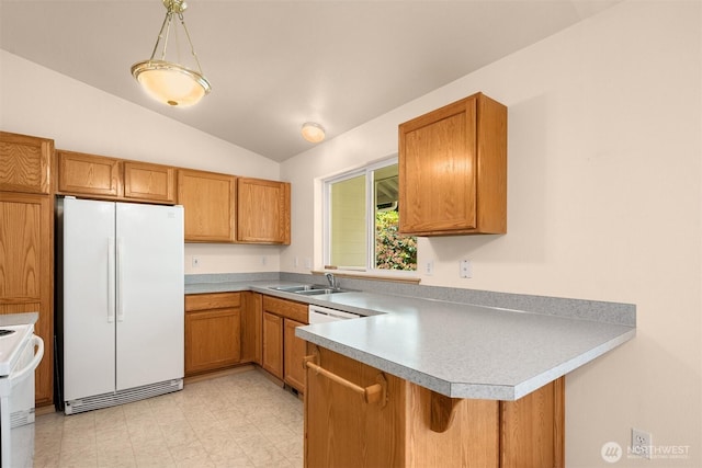 4050 NE 197th St, Lake Forest Park, WA 98155 - kitchen featuring freestanding refrigerator, brown cabinetry, lofted ceiling, a peninsula, and stove