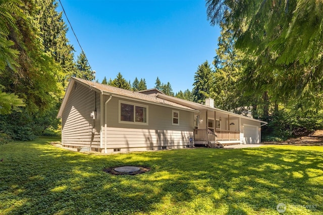 4050 NE 197th St, Lake Forest Park, WA 98155 - back of property with an attached garage, a yard, and a chimney