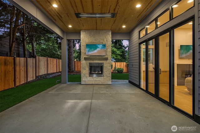 11618 NE 111th St, Kirkland, WA 98033 - fenced backyard with an outdoor stone fireplace and a patio