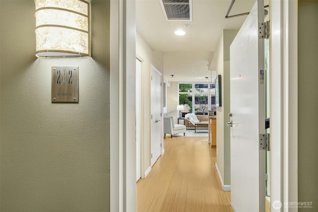 17 W Mercer St Unit 212, Seattle, WA 98119 - corridor with light wood-type flooring and baseboards