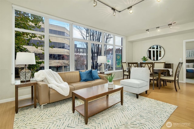 17 W Mercer St Unit 212, Seattle, WA 98119 - living room featuring track lighting, healthy amount of natural light, and light wood-style flooring