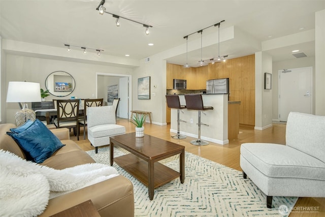 17 W Mercer St Unit 212, Seattle, WA 98119 - living area featuring rail lighting and light wood-type flooring