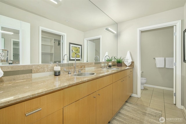 17 W Mercer St Unit 212, Seattle, WA 98119 - bathroom with tile patterned floors, double vanity, and a closet