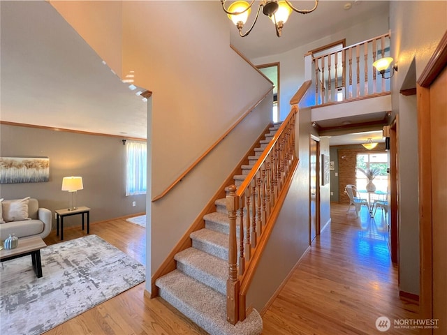 26504 126th Pl SE, Kent, WA 98030 - stairway featuring a chandelier, wood finished floors, and a high ceiling