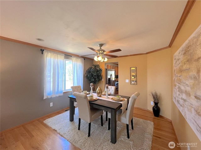 26504 126th Pl SE, Kent, WA 98030 - dining room with light wood-style flooring, ornamental molding, and a ceiling fan