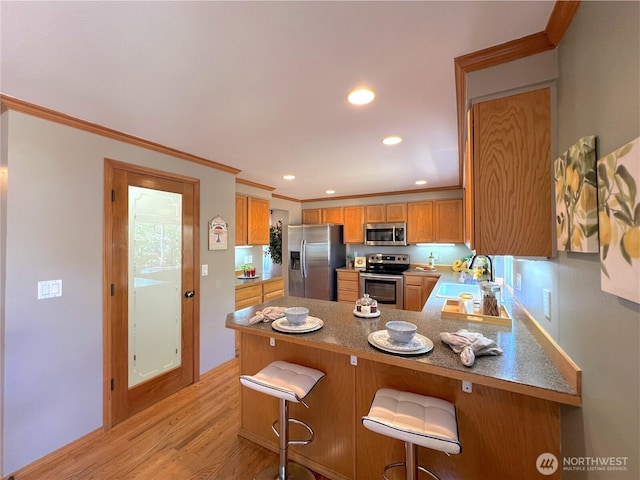 26504 126th Pl SE, Kent, WA 98030 - kitchen with stainless steel appliances, light wood-style flooring, ornamental molding, recessed lighting, and brown cabinetry