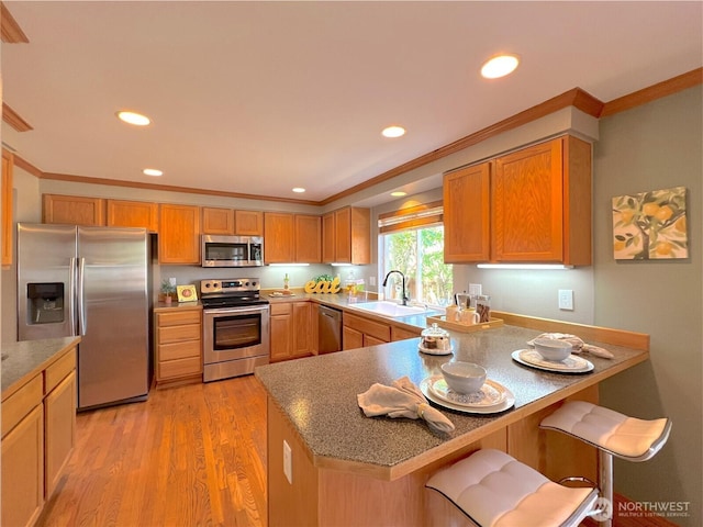 26504 126th Pl SE, Kent, WA 98030 - kitchen with appliances with stainless steel finishes, crown molding, a peninsula, recessed lighting, and light wood-style floors