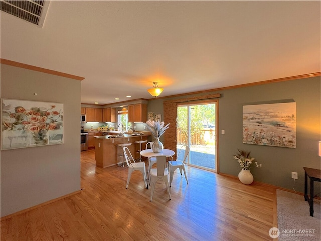 26504 126th Pl SE, Kent, WA 98030 - dining space with light wood-style flooring, ornamental molding, healthy amount of natural light, and recessed lighting