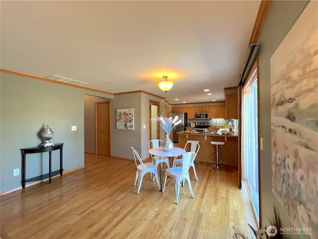 26504 126th Pl SE, Kent, WA 98030 - dining area with light wood-type flooring, crown molding, and recessed lighting