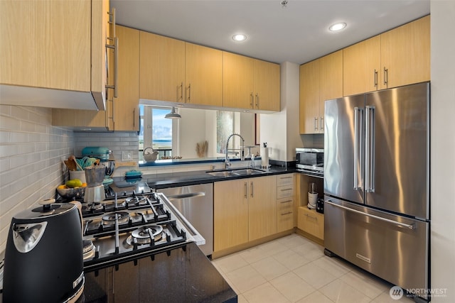 2721 1st Ave Unit 1101, Seattle, WA 98121 - kitchen with stainless steel appliances, dark countertops, light brown cabinets, recessed lighting, and decorative backsplash