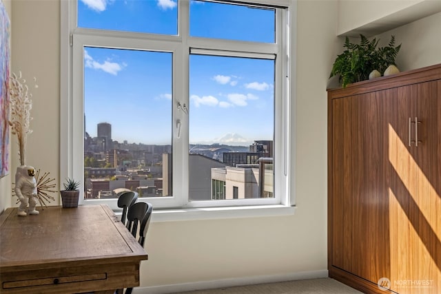 2721 1st Ave Unit 1101, Seattle, WA 98121 - home office with healthy amount of natural light, a view of city, and carpet floors