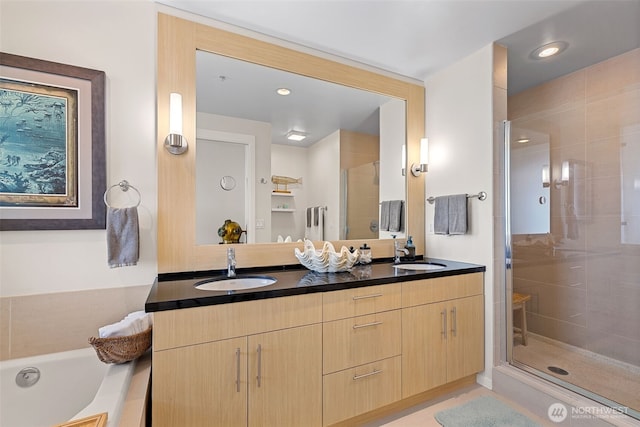 2721 1st Ave Unit 1101, Seattle, WA 98121 - full bathroom with double vanity, a shower stall, a bath, and recessed lighting