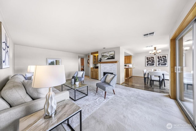 9727 NE Juanita Dr Unit 308, Kirkland, WA 98034 - living area with a chandelier, light colored carpet, and a fireplace