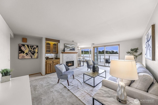 9727 NE Juanita Dr Unit 308, Kirkland, WA 98034 - living room featuring a fireplace and light carpet