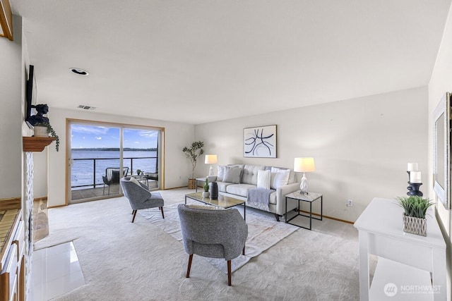 9727 NE Juanita Dr Unit 308, Kirkland, WA 98034 - living area with light carpet and a water view