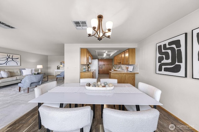 9727 NE Juanita Dr Unit 308, Kirkland, WA 98034 - dining space featuring a chandelier and dark wood-type flooring