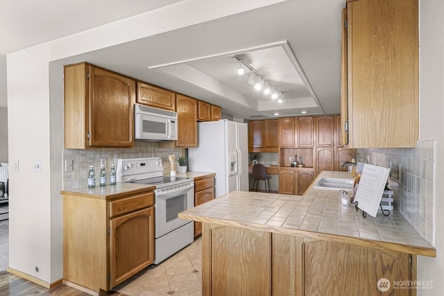 9727 NE Juanita Dr Unit 308, Kirkland, WA 98034 - kitchen with white appliances, a raised ceiling, tile counters, and tasteful backsplash