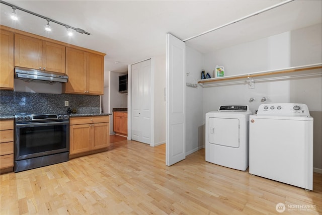 6405 Sand Point Way NE, Seattle, WA 98115 - kitchen with electric stove, under cabinet range hood, separate washer and dryer, and light wood-style floors