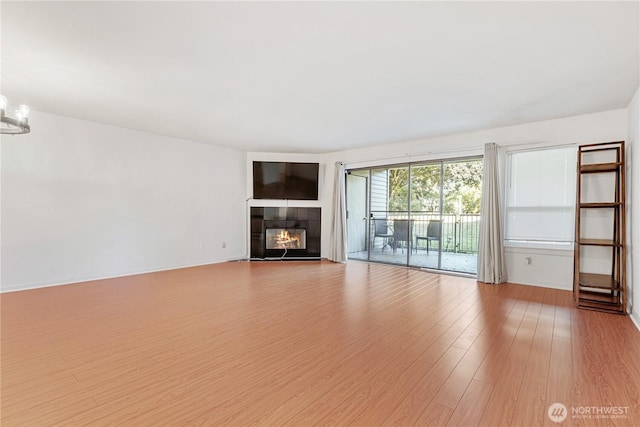 6405 Sand Point Way NE, Seattle, WA 98115 - unfurnished living room featuring light wood-type flooring and a tiled fireplace