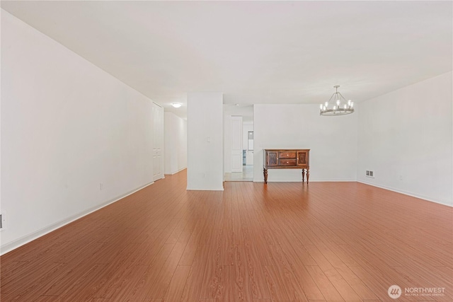 6405 Sand Point Way NE, Seattle, WA 98115 - unfurnished living room featuring a chandelier and light wood finished floors