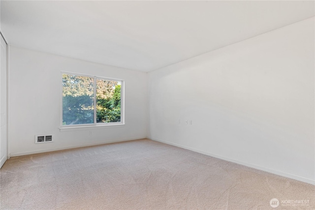 6405 Sand Point Way NE, Seattle, WA 98115 - spare room featuring light carpet and baseboards