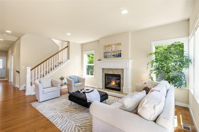 1501 209th Ave NE, Sammamish, WA 98074 - living area featuring stairs, wood finished floors, a high end fireplace, and recessed lighting