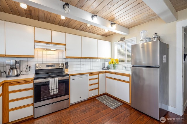 4421 Sucia Dr, Ferndale, WA 98248 - kitchen featuring stainless steel appliances, extractor fan, light countertops, dark wood-style flooring, and decorative backsplash
