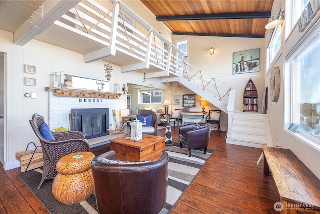 4421 Sucia Dr, Ferndale, WA 98248 - living area featuring a wooden ceiling with exposed beams, a brick fireplace, stairway, hardwood / wood-style flooring, and high vaulted ceiling